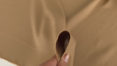 Margine prinsă între degete, cu față și revers mate în nuanță cappuccino