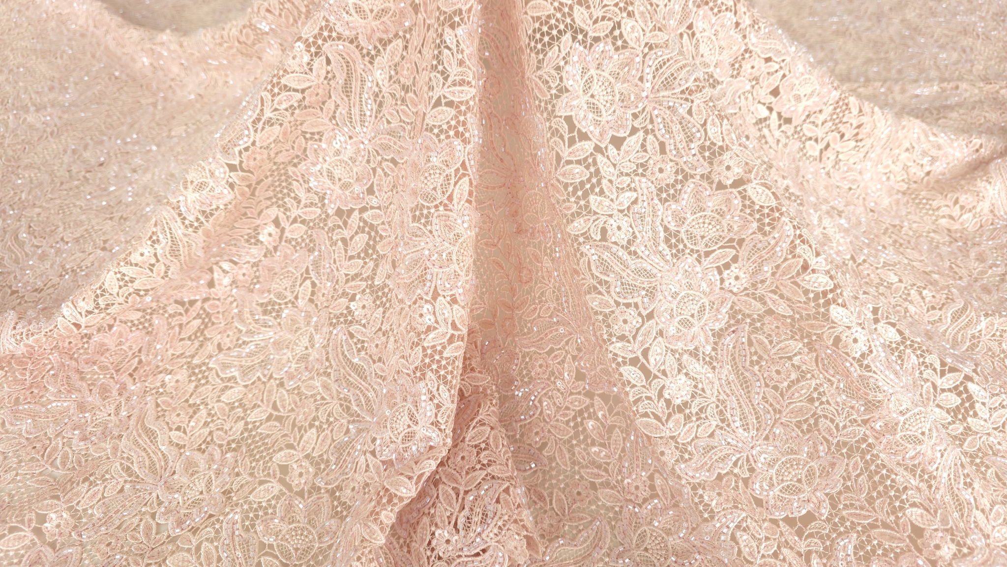 Colțul materialului ridicat ușor arătând flexibilitatea și căderea naturală