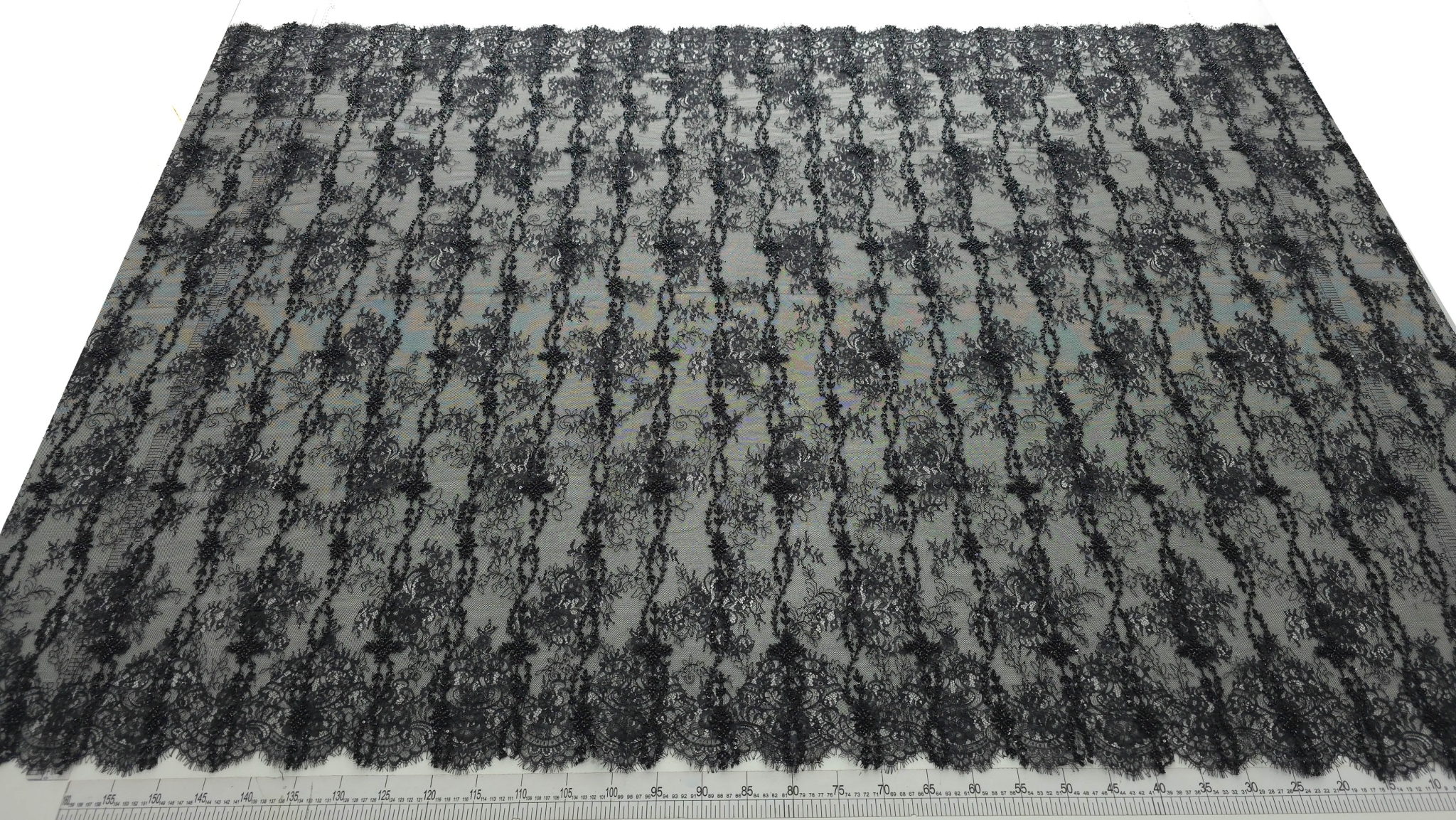 Dantelă neagră tip chantilly ELARA cu micropaiete și mărgele, vedere de ansamblu pe fundal deschis