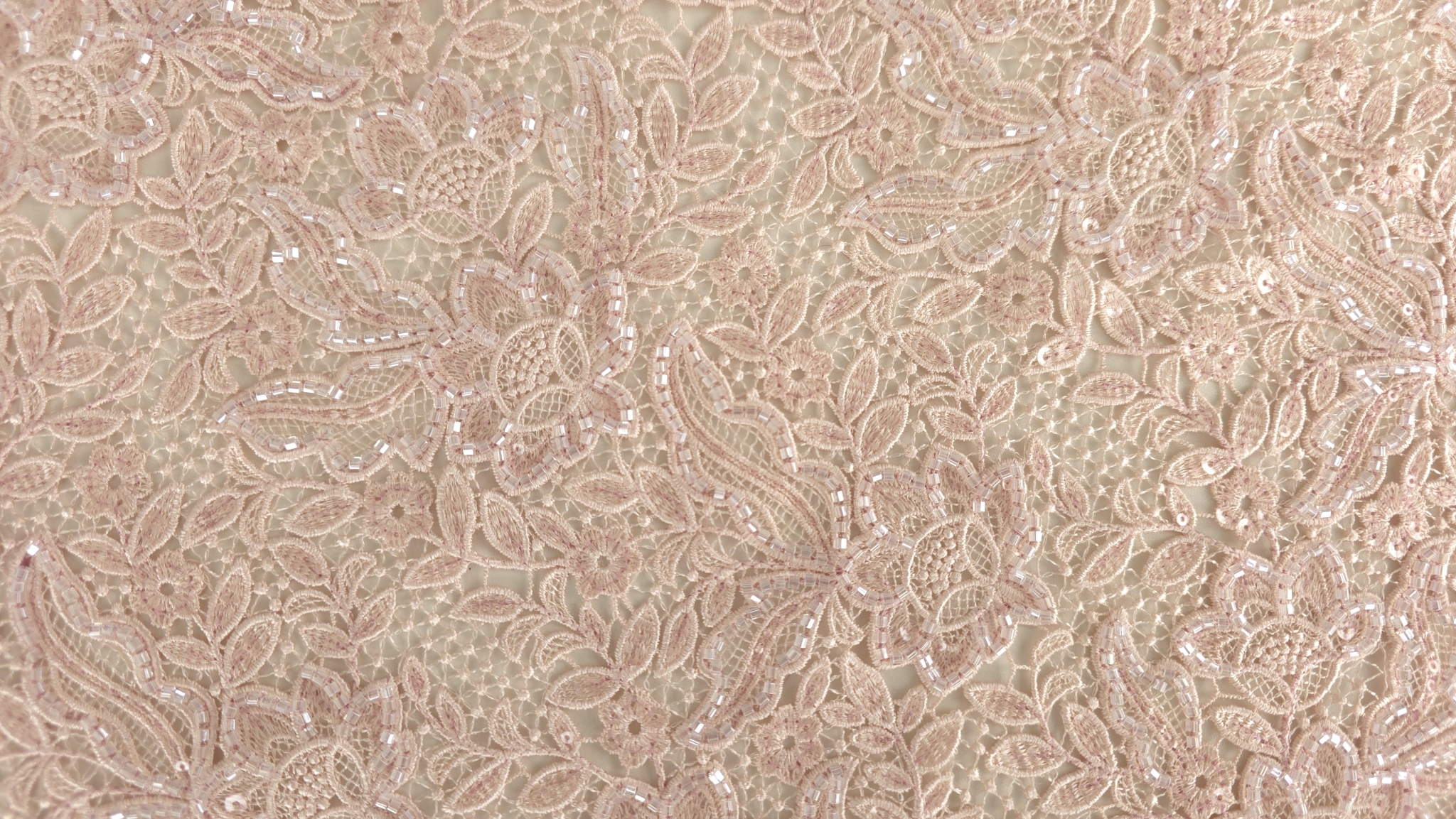 Detaliu macro pe petale și frunze brodate cu aplicații transparente pe contururi