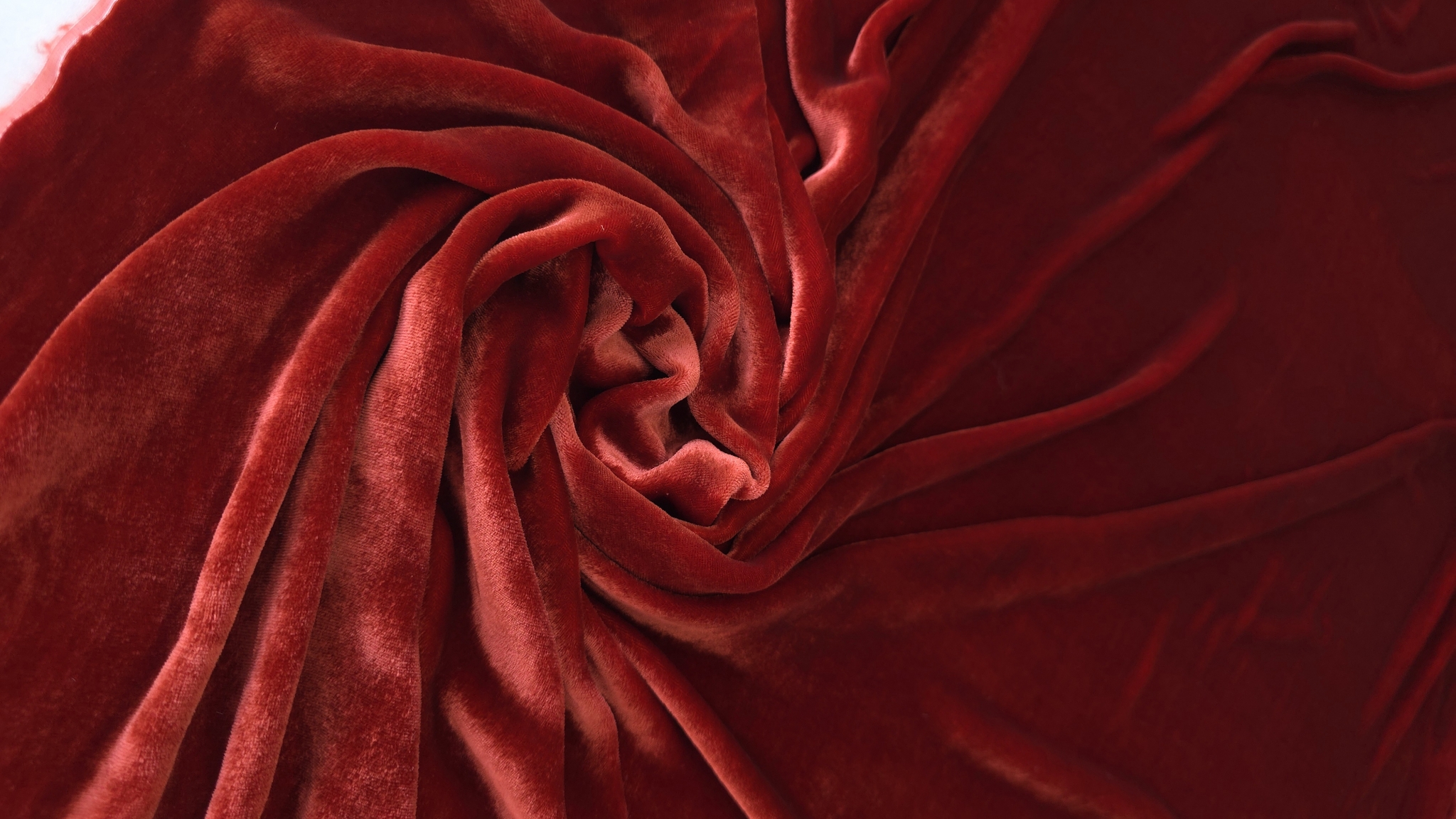 Falduri diagonale pe catifea grenadine cu zone mai închise și mai deschise