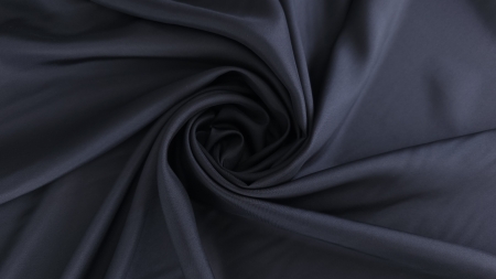 Chiffon dublu bleumarin din mătase naturală aranjat în spirală pe fundal deschis