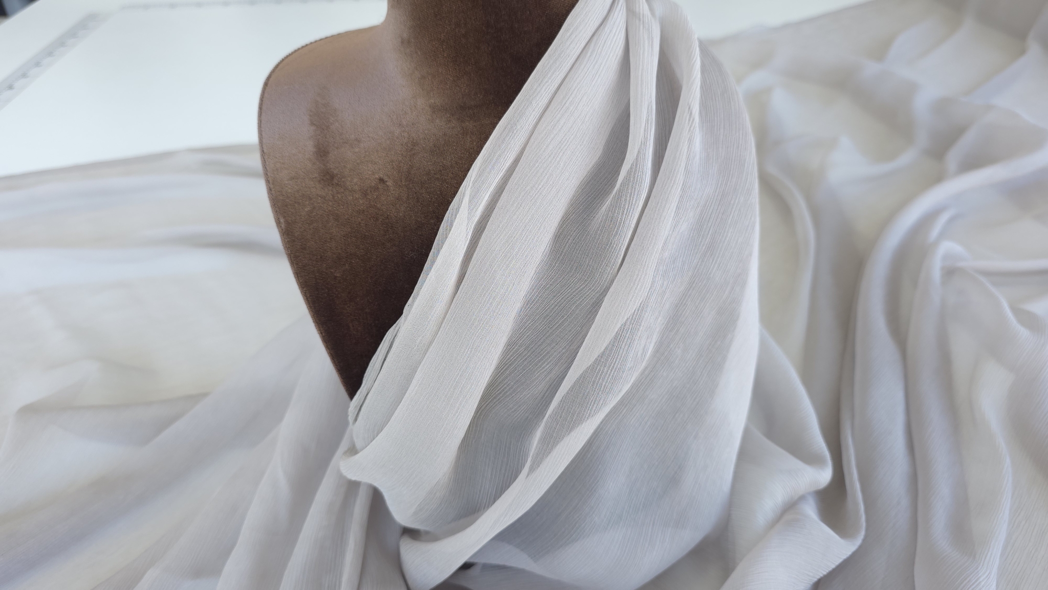 Voal de mătase gri grej drapat pe bust de prezentare cu falduri vizibile