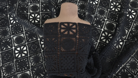 Structură modulară în pătrățele negre pe manechin, motive geometrice alternante vizibile
