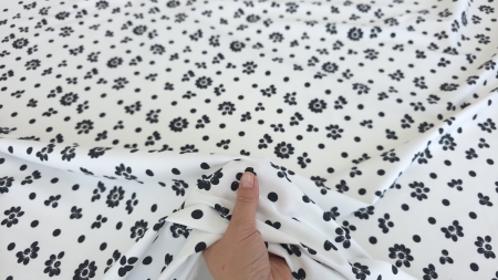 Poplin alb cu flori negre strans in mana