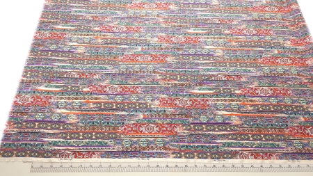 Satin imprimat cu model abstract din mătase naturală multicolor cod PCS124 EV61D întins pe masă lângă riglă