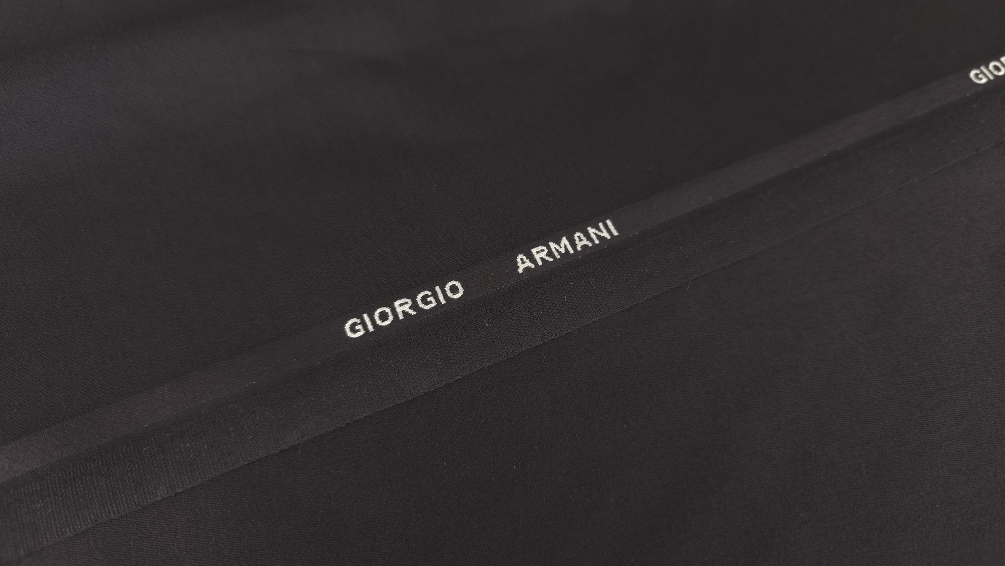 margine tesuta cu marcaj Giorgio Armani pe fond negru